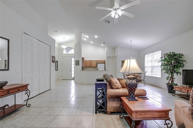 living room featuring high vaulted ceiling, ceiling fan, and light tile patterned flooring