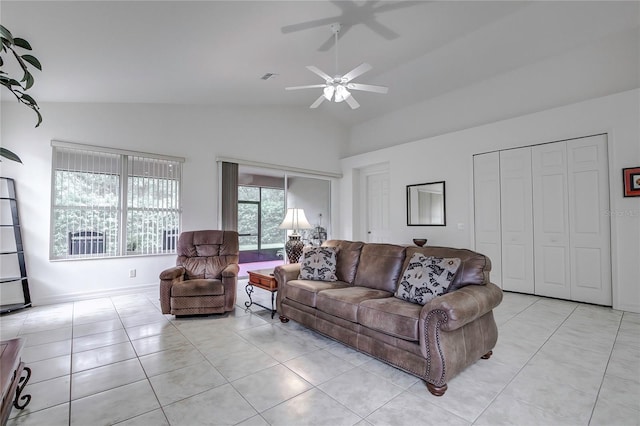 living room featuring ceiling fan, light tile patterned floors, and lofted ceiling