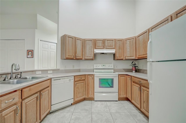 kitchen featuring sink, white appliances, and light tile patterned flooring