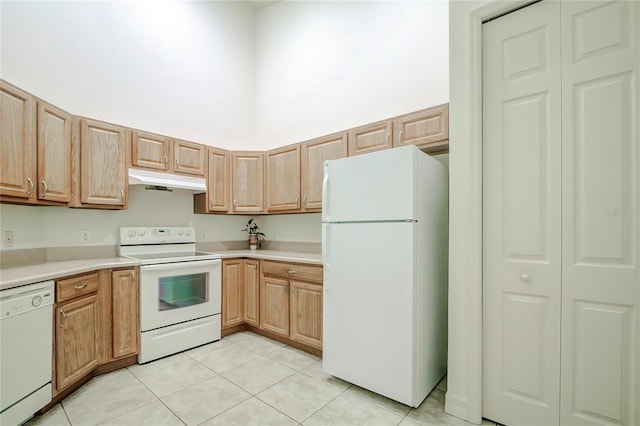 kitchen with light tile patterned flooring and white appliances