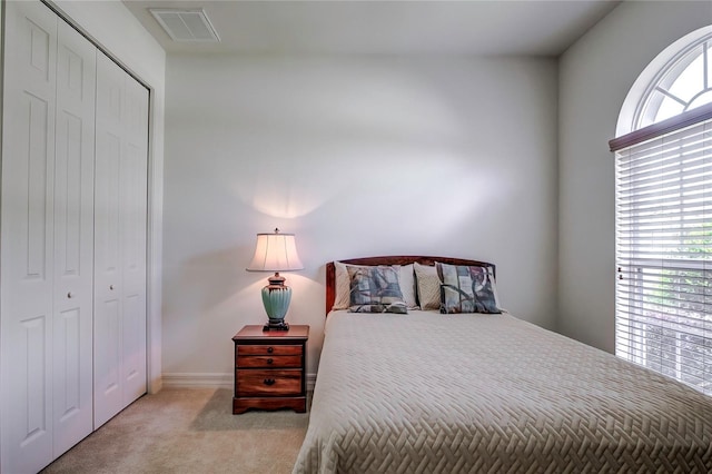 carpeted bedroom with a closet