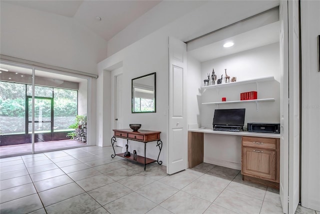 kitchen featuring light tile patterned floors and built in desk