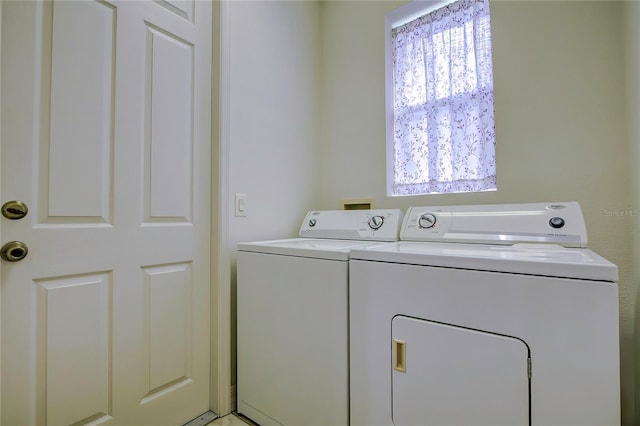 laundry area with independent washer and dryer