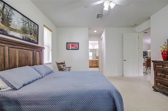 carpeted bedroom with ceiling fan and ensuite bathroom