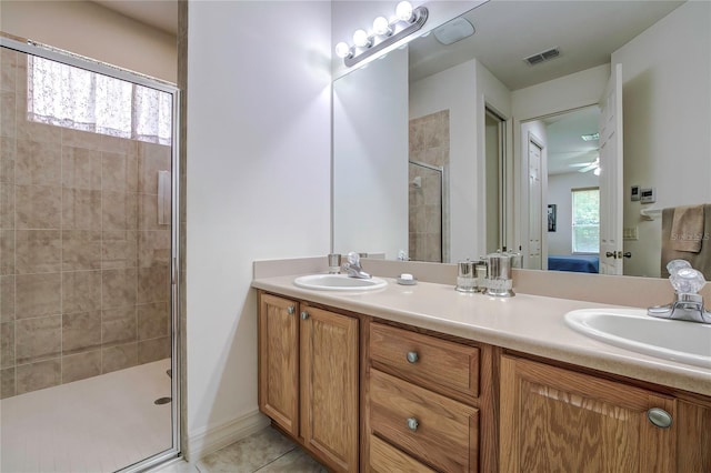 bathroom with vanity, an enclosed shower, and tile patterned flooring