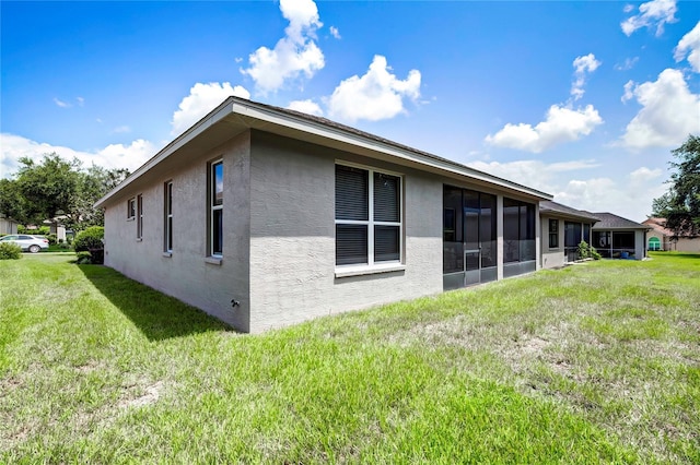 view of side of home with a yard