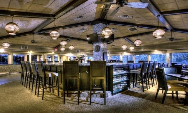 bar with ceiling fan, carpet flooring, and vaulted ceiling