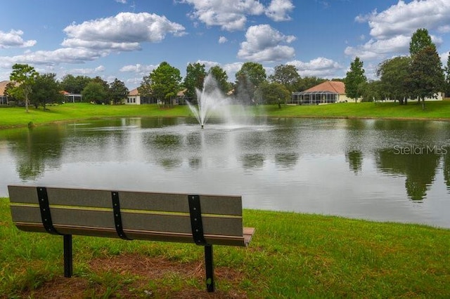 view of community featuring a water view and a yard