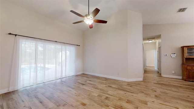 unfurnished room with ceiling fan, light wood-type flooring, and lofted ceiling