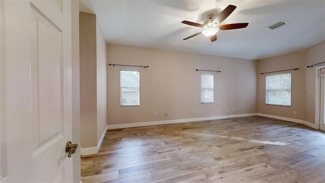 empty room featuring ceiling fan and light hardwood / wood-style flooring