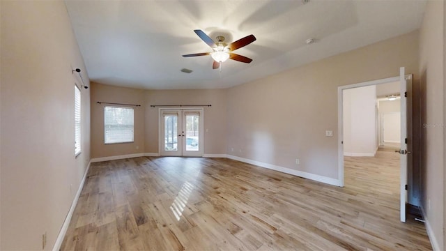 spare room featuring ceiling fan, french doors, and light hardwood / wood-style flooring