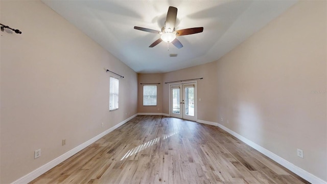 spare room with ceiling fan, light hardwood / wood-style flooring, a wealth of natural light, and french doors