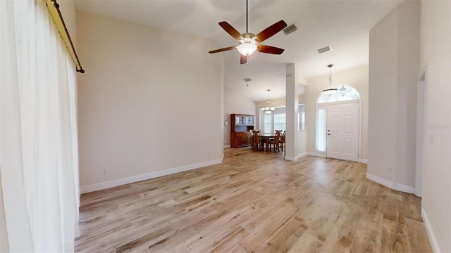 foyer entrance featuring ceiling fan, light hardwood / wood-style floors, and lofted ceiling