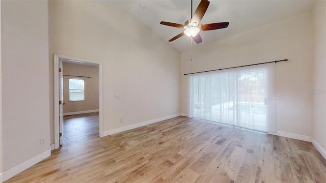 spare room featuring high vaulted ceiling, light hardwood / wood-style flooring, and ceiling fan