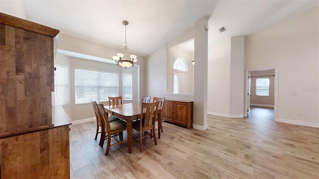 dining space with an inviting chandelier and light hardwood / wood-style flooring