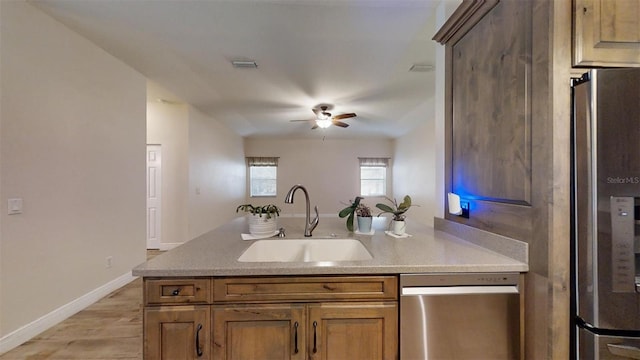 kitchen with sink, stainless steel appliances, ceiling fan, and light hardwood / wood-style floors