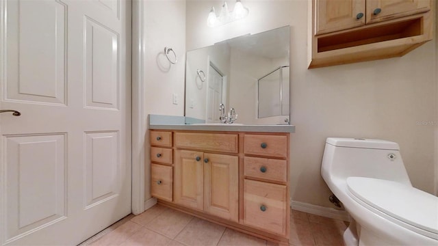 bathroom featuring tile patterned floors, toilet, and vanity