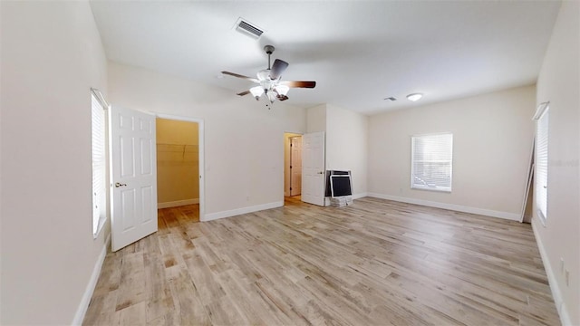 unfurnished living room with light wood-type flooring and ceiling fan