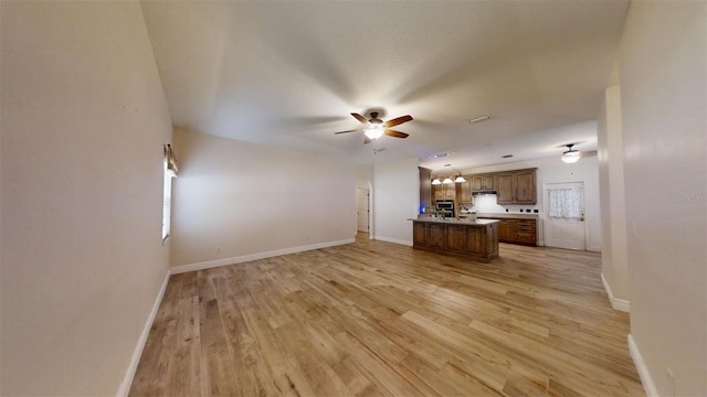 unfurnished living room featuring ceiling fan and light hardwood / wood-style flooring