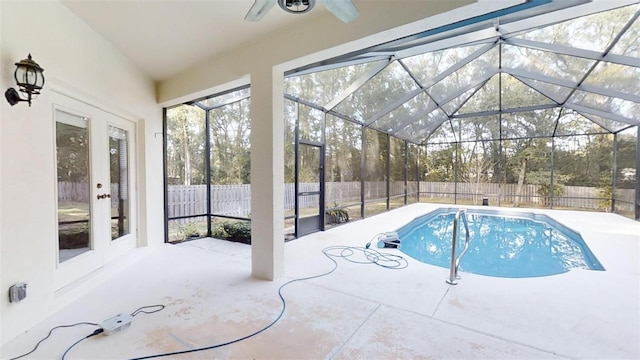 view of pool featuring glass enclosure, french doors, a patio area, and ceiling fan