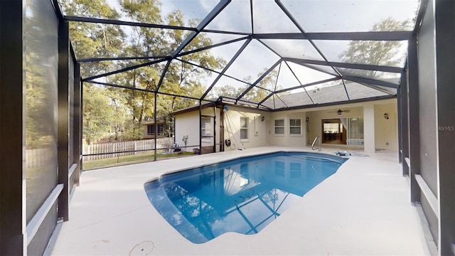 view of swimming pool with a lanai, a patio, and ceiling fan