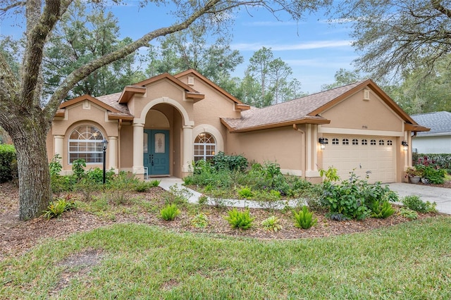 view of front facade with a front yard and a garage