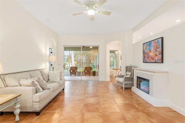 living room featuring light tile patterned flooring and ceiling fan