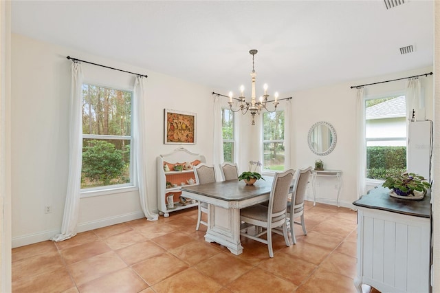 tiled dining space with a notable chandelier and a healthy amount of sunlight