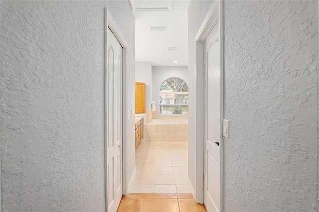 corridor with light tile patterned floors