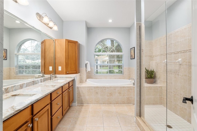 bathroom with vanity, a healthy amount of sunlight, separate shower and tub, and tile patterned flooring