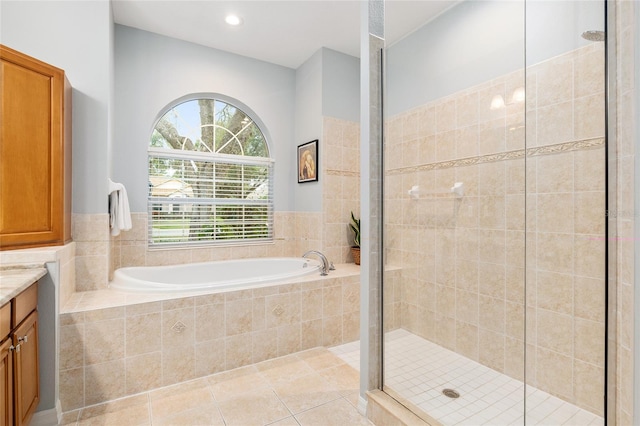 bathroom with tile patterned floors, vanity, and separate shower and tub