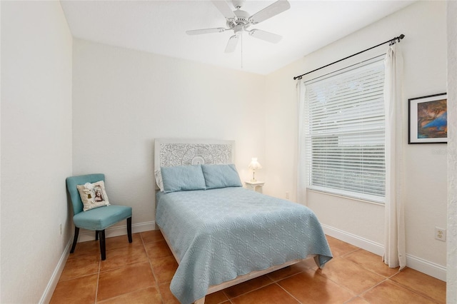 bedroom with ceiling fan and tile patterned flooring