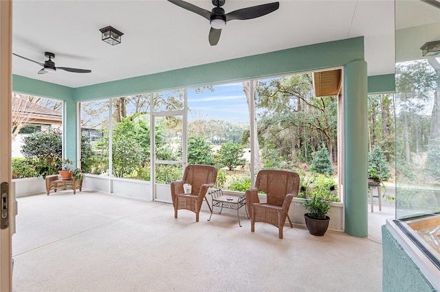 sunroom / solarium featuring ceiling fan