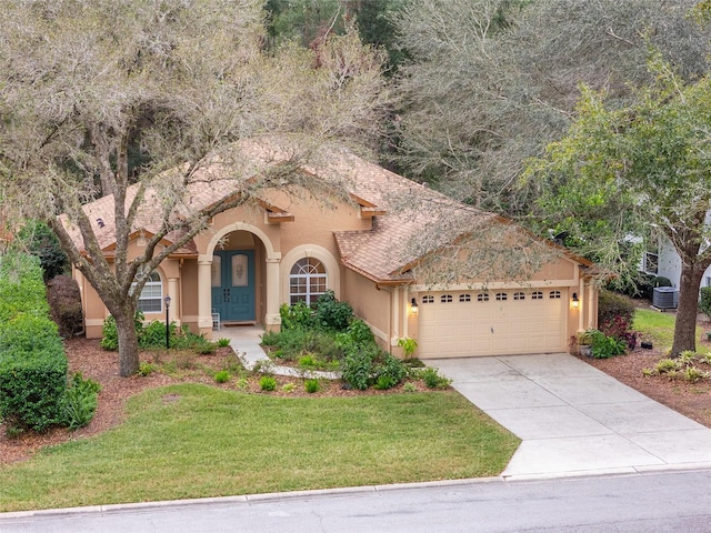 view of front of property featuring a garage and a front lawn