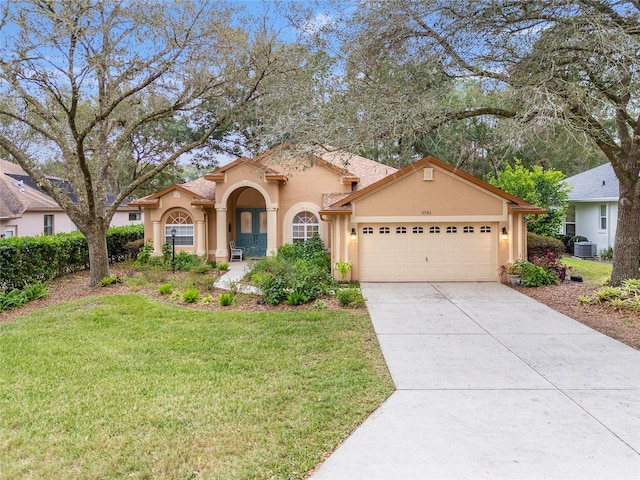 view of front of property featuring a garage, a front yard, and central air condition unit