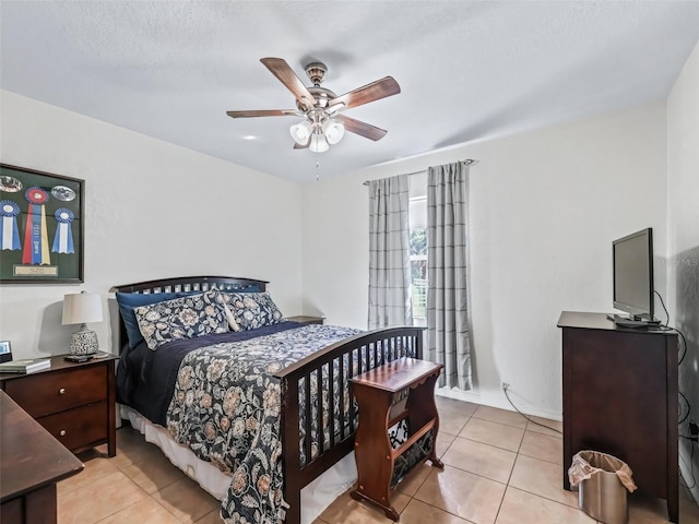 tiled bedroom featuring ceiling fan and a textured ceiling