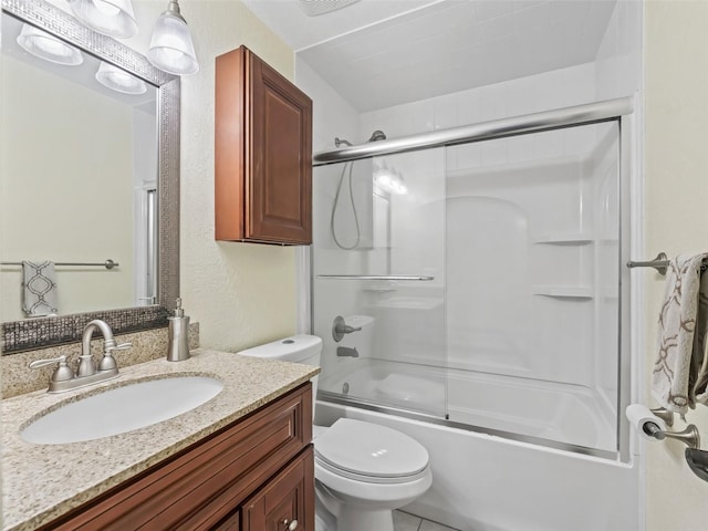 bathroom featuring visible vents, toilet, shower / bath combination with glass door, vanity, and a textured wall