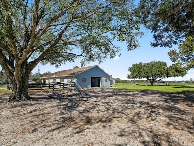 view of outbuilding with fence