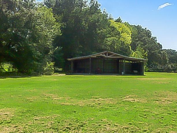 view of community featuring a yard and a detached carport