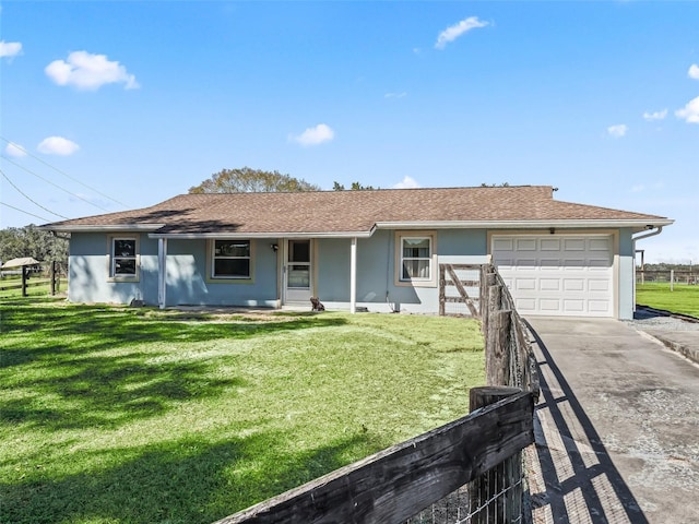 view of front of home with a front lawn, a garage, driveway, and stucco siding