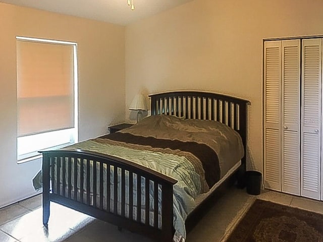 tiled bedroom featuring a closet