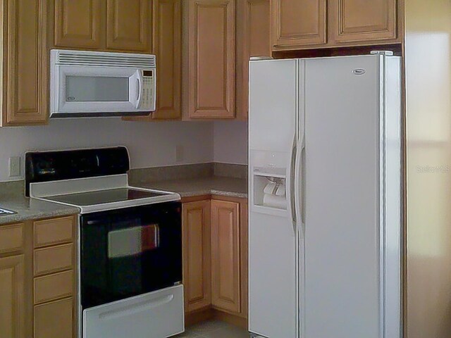 kitchen featuring white appliances and light countertops