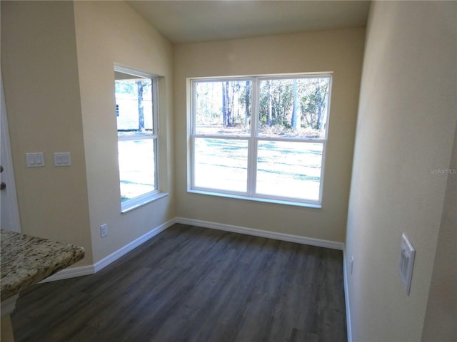 unfurnished dining area featuring dark hardwood / wood-style flooring