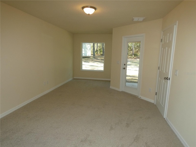 unfurnished room with light carpet