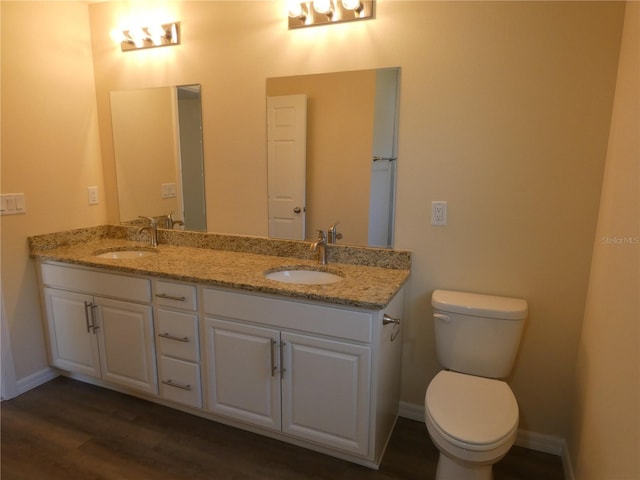 bathroom featuring hardwood / wood-style flooring, vanity, and toilet