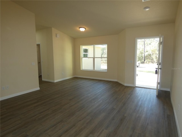 empty room with dark wood-type flooring