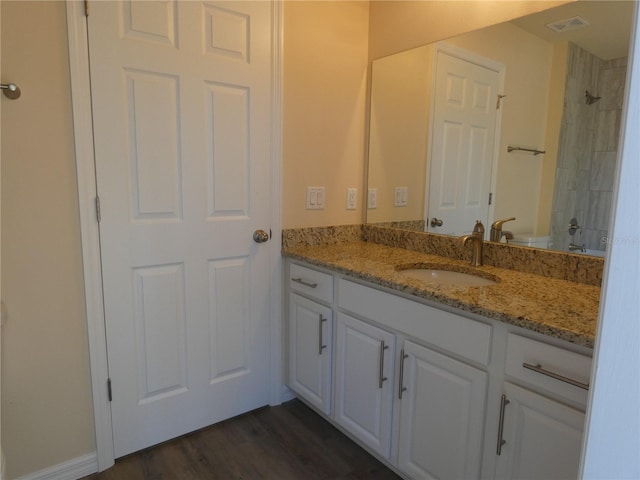 bathroom with vanity, hardwood / wood-style floors, and walk in shower