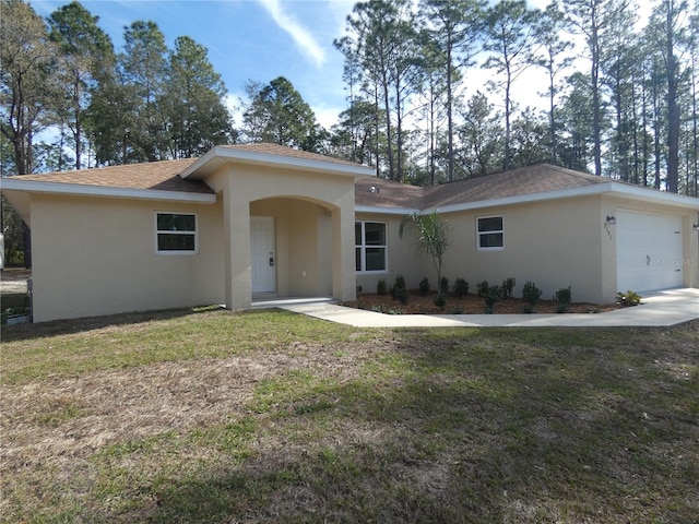 view of front facade with a garage and a front lawn