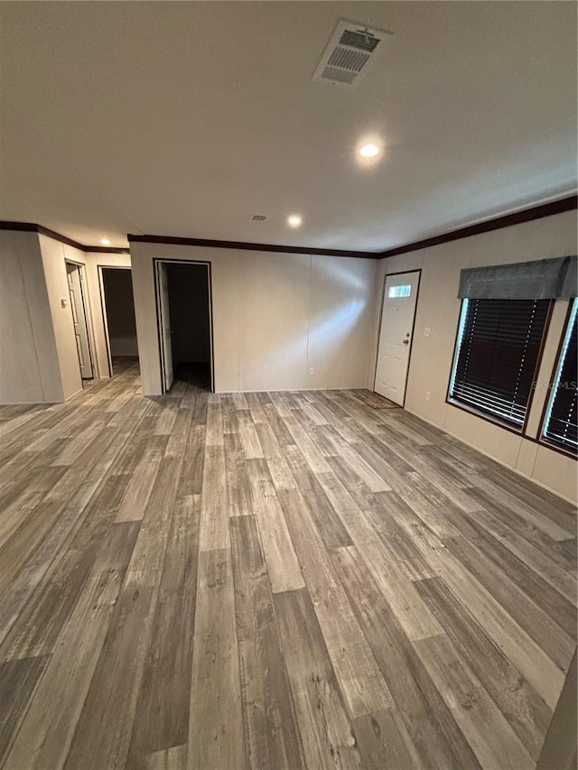 interior space featuring hardwood / wood-style floors and ornamental molding