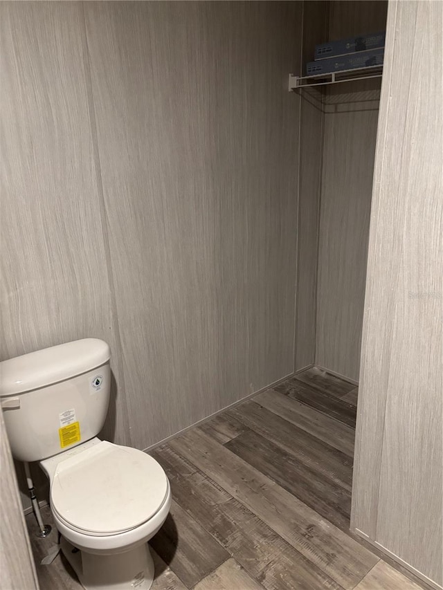 bathroom with hardwood / wood-style floors and toilet